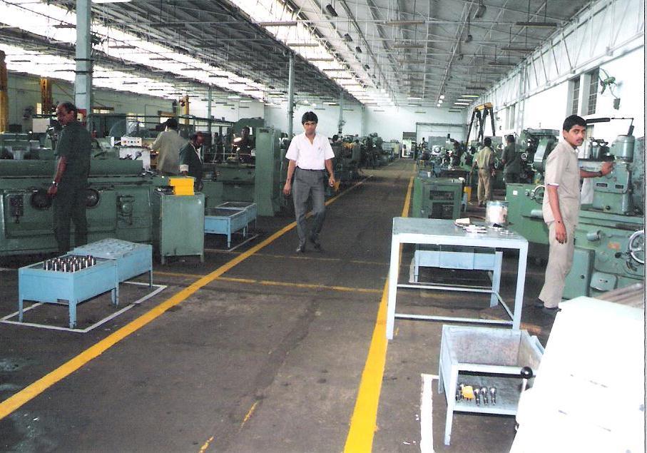 A shop floor laid out for flow: machines in line, walkways and work areas marked on the floor in yellow.